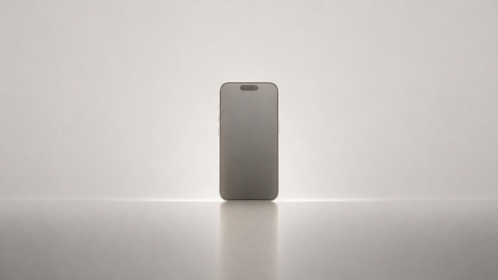 A smartphone standing upright on a softly lit surface